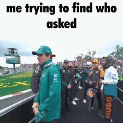 Man In Green Jacket Standing In Crowd Saying Me Trying To Find Who Asked GIF