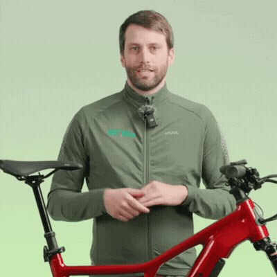 Man In Green Jacket With Alpina Beside Red Bike GIF