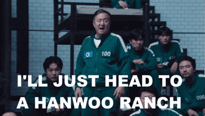 Man In Green Jacket With Number 100 In Front Of Group GIF