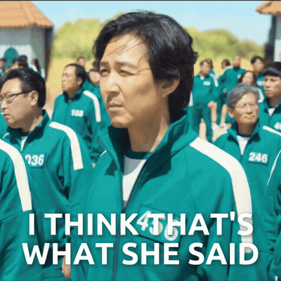 Man In Green Jacket With Number 246 Standing In Crowd GIF