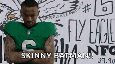 Man In Green Jersey Arms Crossed Says Skinny Batman GIF