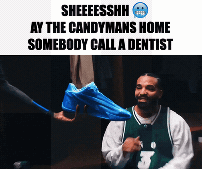 Man In Green Jersey Holding Blue Sneakers GIF