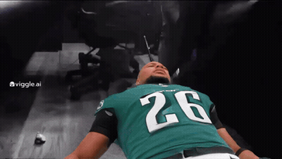 Man In Green Jersey Number 26 Laying On Floor GIF