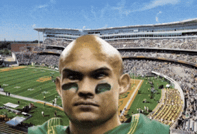 Man In Green Jersey With Sticker On Face In Stadium GIF