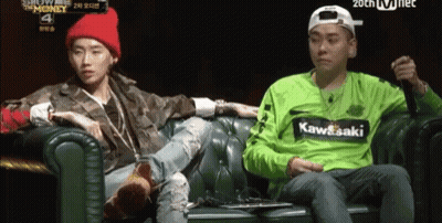 Man In Green Kawasaki Shirt Sitting Next To Man On Couch GIF