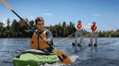 Man In Green Kayak Towed By Two People GIF