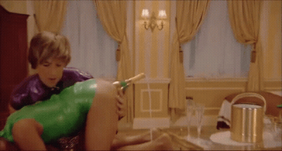 Man In Green Leotard Holding Woman GIF