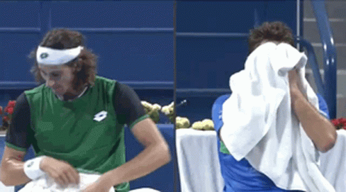 Man In Green Lotto Shirt Wiping Face GIF