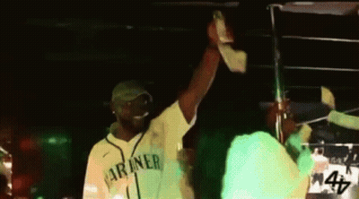 Man in Green Mariners Jersey Holding Up Hand