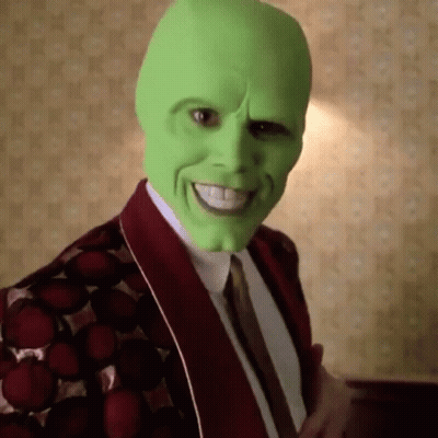 Man In Green Mask And Red Jacket Smiling GIF