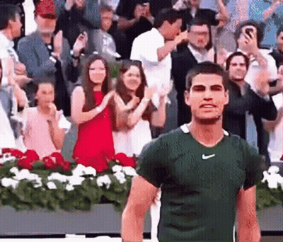 Man In Green Nike Shirt Walking In Front Of Crowd GIF