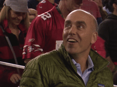 Man In Green Patagonia Jacket Looking Down GIF
