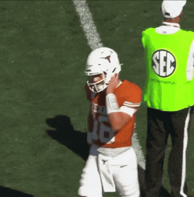 Man In Green Sec Vest Behind Football Player GIF