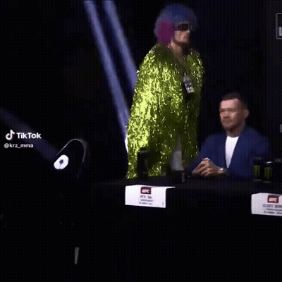 Man In Green Sequined Outfit Dancing At Bud Light Sign GIF