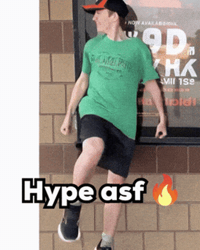 Man In Green Shirt And Black Shorts In Front Of Hype Sign GIF