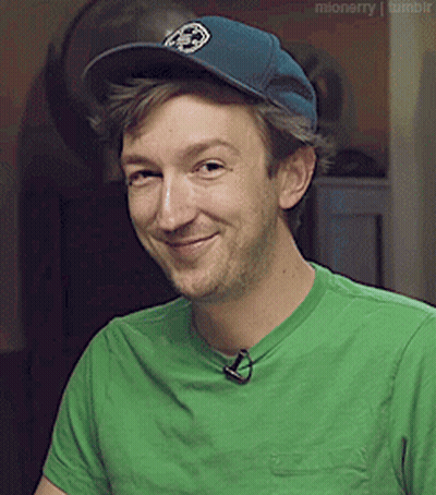 Man In Green Shirt And Blue Hat Smiling GIF