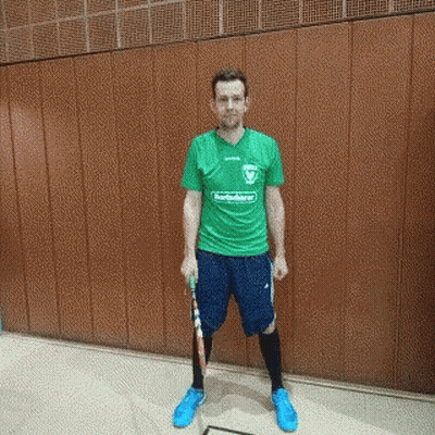Man In Green Shirt And Blue Shorts Holding Racket GIF