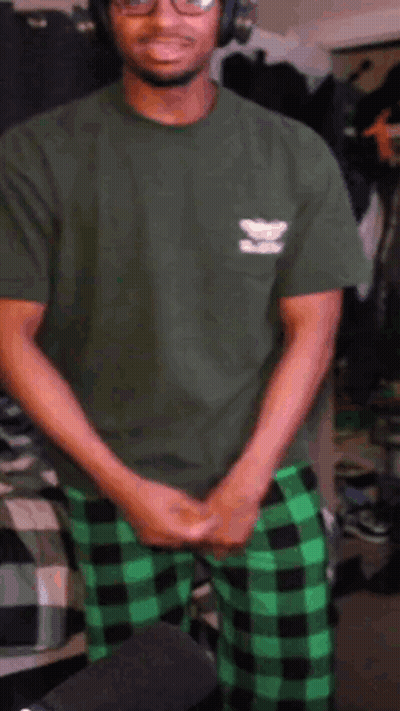 Man In Green Shirt And Plaid Pants At Microphone GIF