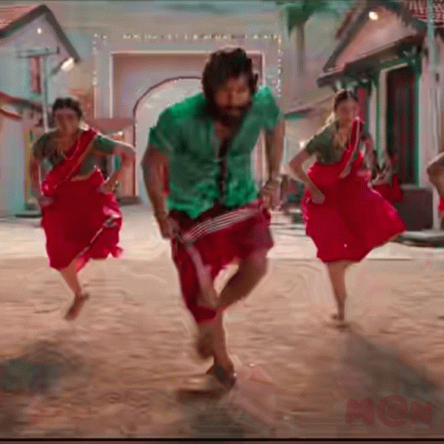 Man In Green Shirt And Red Pants Dancing With Two Women In Red GIF