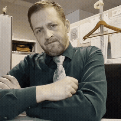 Man In Green Shirt And Tie At Desk GIF