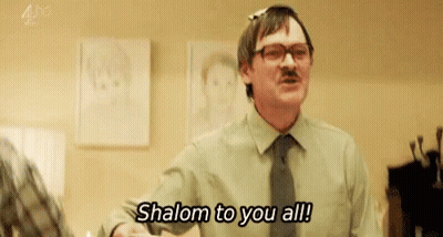 Man In Green Shirt And Tie Saying Shalom To You All GIF
