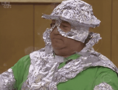 Man In Green Shirt And Tin Foil Hat GIF