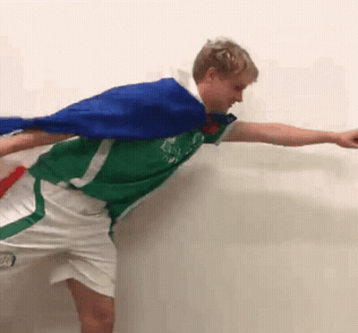 Man In Green Shirt And White Shorts Holding Blue Cape GIF