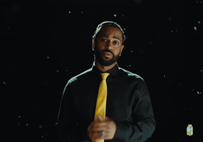 Man in Green Shirt and Yellow Tie with Lemonade Carton