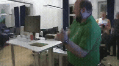 Man In Green Shirt At Computer Desk GIF