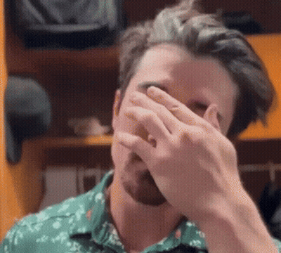 Man In Green Shirt Covering Face GIF