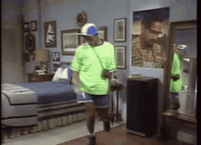 Man In Green Shirt Dancing In Bedroom GIF