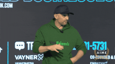 Man In Green Shirt Dancing In Front Of Hall Of Fame Sign GIF