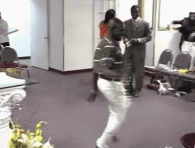 Man In Green Shirt Dancing In Hallway GIF