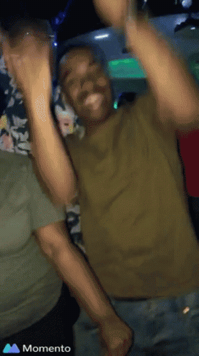 Man In Green Shirt Dancing With Hands Up Saying Momento GIF