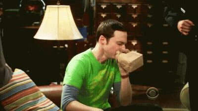 Man In Green Shirt Eating Food On Couch GIF