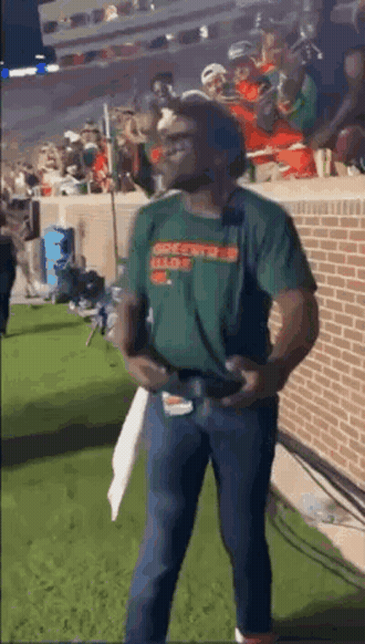 Man In Green Shirt Holding Football GIF