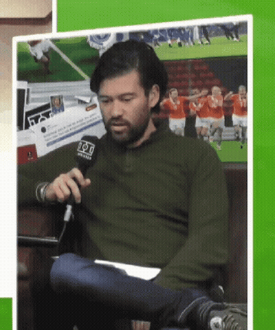 Man In Green Shirt Holding Fox Microphone GIF