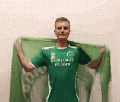 Man In Green Shirt Holding Green Scarf GIF