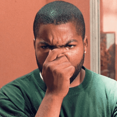 Man In Green Shirt Holding Nose GIF