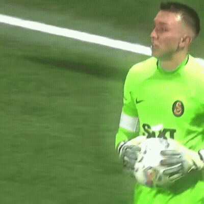 Man In Green Shirt Holding Soccer Ball GIF