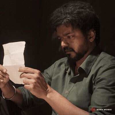 Man In Green Shirt Holding Sony Music Paper GIF
