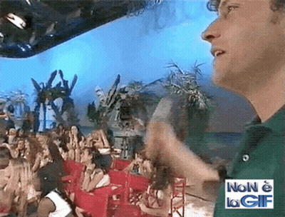 Man In Green Shirt In Front Of Crowd With Sign Non E La Gif
