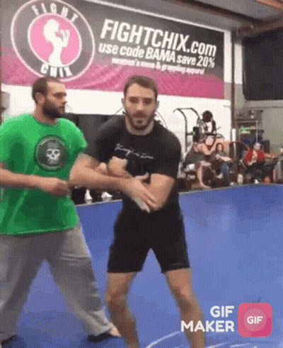 Man In Green Shirt In Front Of Fightchix.com Sign GIF