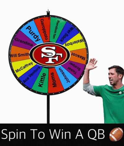 Man In Green Shirt In Front Of Spin To Win QB Game GIF