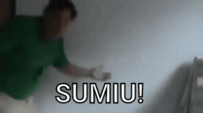 Man In Green Shirt In Front Of Sumiu GIF