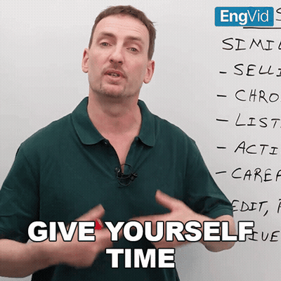 Man In Green Shirt In Front Of White Board Saying Give Yourself Time GIF