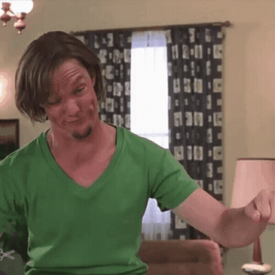 Man In Green Shirt Looking At Camera With Pause GIF
