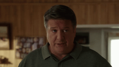 Man In Green Shirt Looking GIF