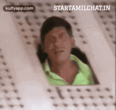 Man In Green Shirt Looking Out Window GIF