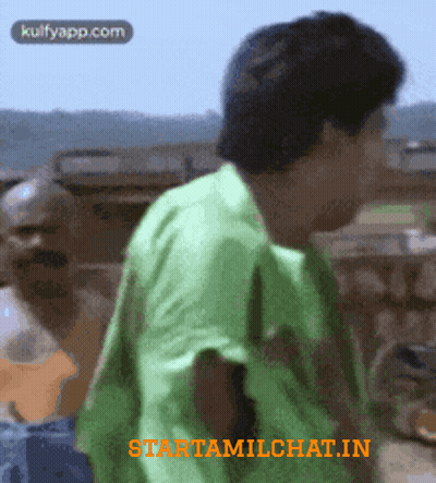 Man In Green Shirt Next To Man In Blue GIF